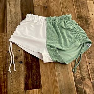 These are Five Dance Wear shorts. They’re green and white. Size YXL.